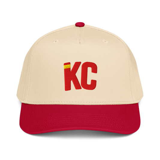 Beige and red baseball cap with 'KC' logo on a white background